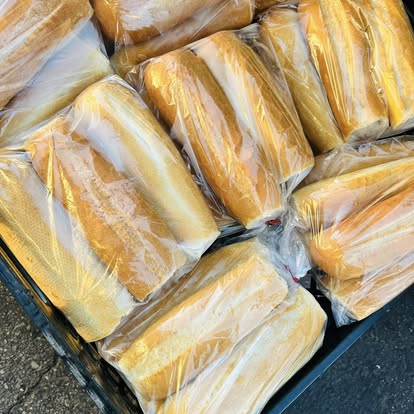 Crate of golden lepinja loaves bagged and ready to go