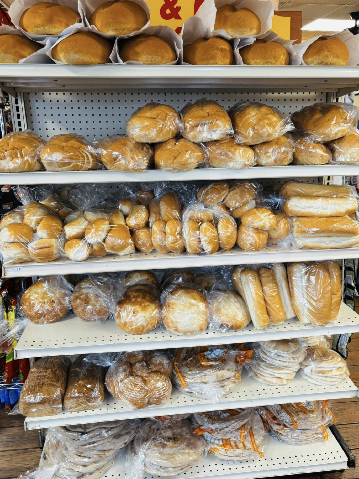 Bakery shelves loaded with somun, lepinja and pita bread