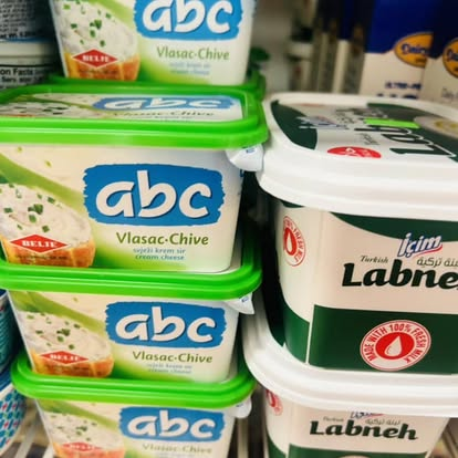 Tubs of ABC Vlasac-Chive cream cheese stacked next to Turkish Labneh