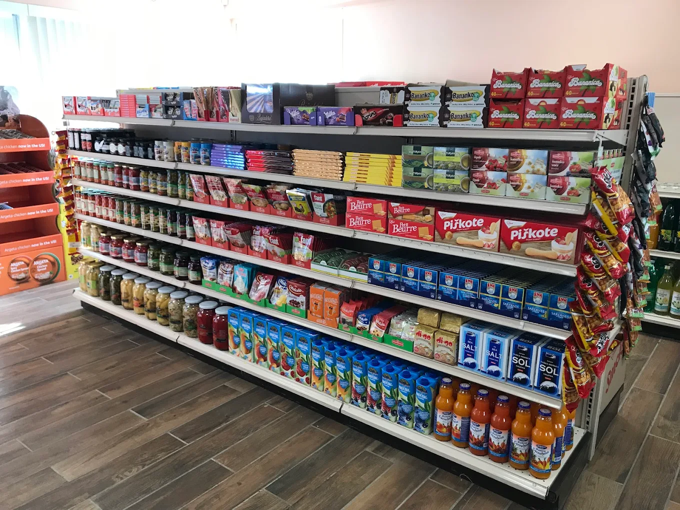 Shop interior with market aisles stocked with European groceries